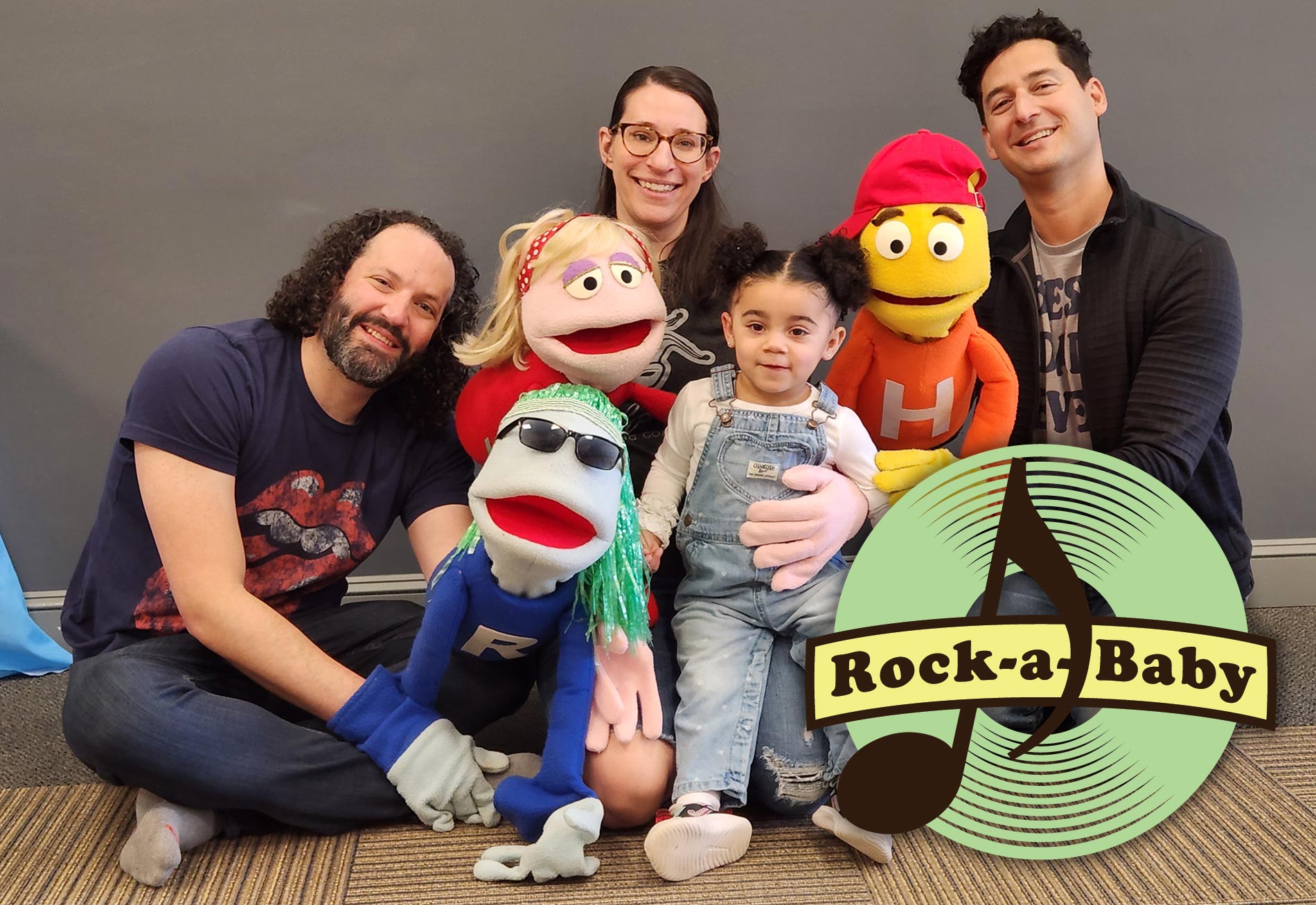 toddler enjoying music class with teachers and puppets in RI and MA